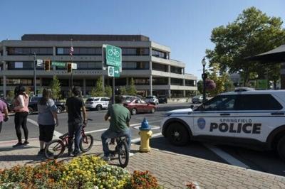 People watch as Springfield Police Department officers investigate the Springfield City Hall after bomb threats were made against buildings earlier in the day in Springfield, Ohio, on September 12, 2024