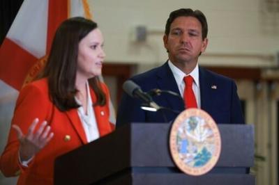 Florida Governor Ron DeSantis listens as state Attorney General Ashley Moody speaks about the prospect of state criminal charges being filed against the man suspected of attempting to assassinate former US president Donald Trump
